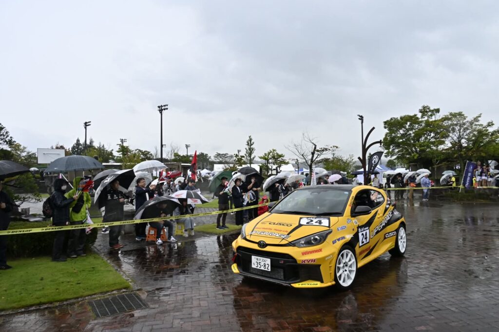 スタートゲートをくぐり出発する競技車両